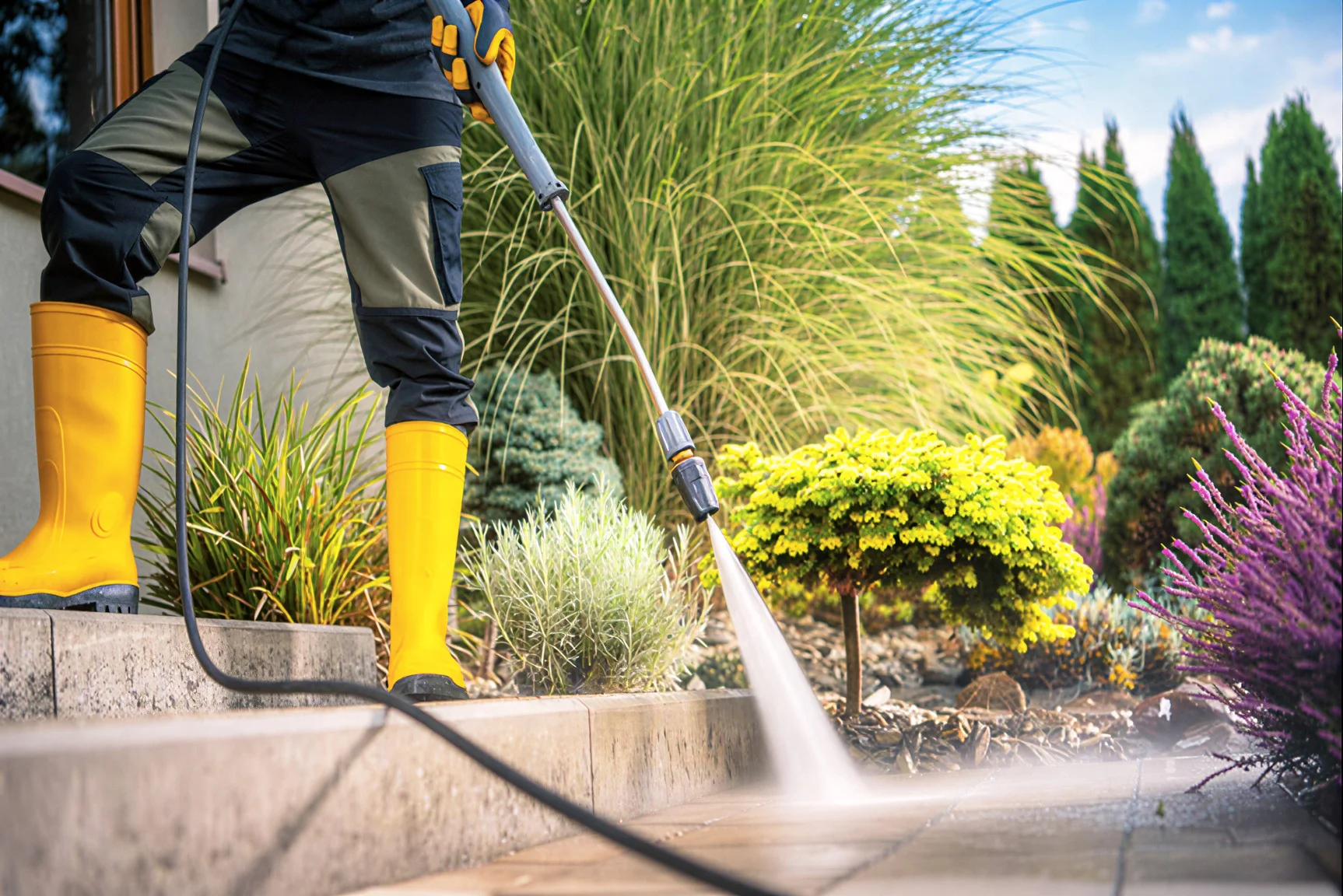 Residential Pressure Washing - Sidewalk Cleaning a man cleaning a concrete home entry with a pressure washer machine