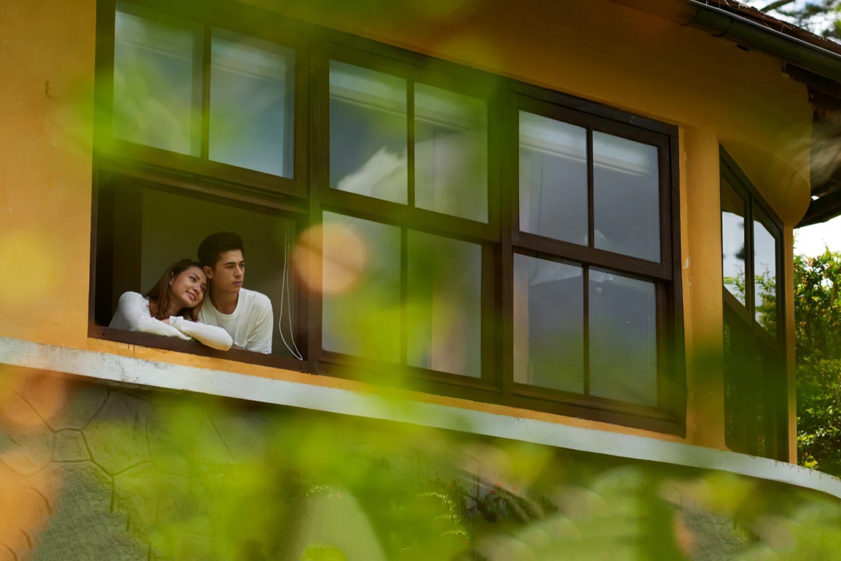 A couple in a home windows seeing the garden