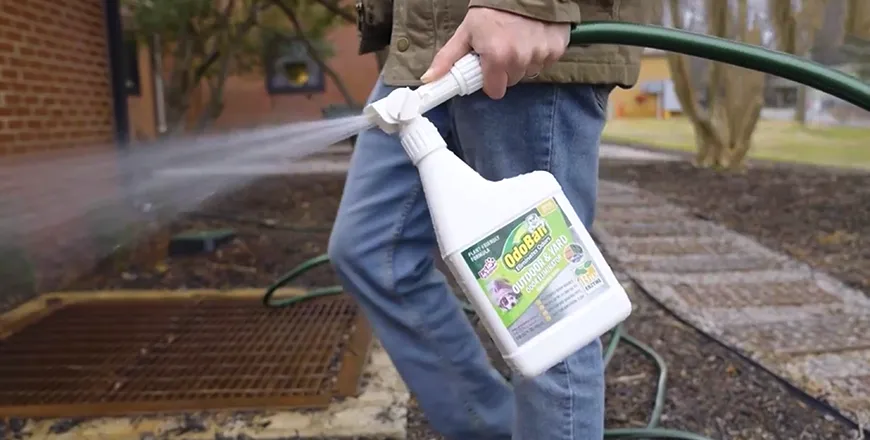 Odor Ban Eliminator a man with a hose in their hand spraying a odor ban eliminator